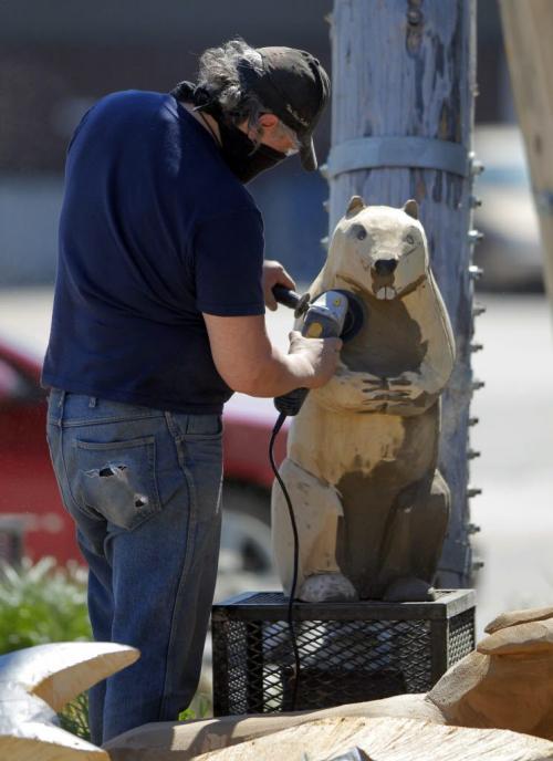 Dwayne Ball carves some animals on Sutherland in front of the Manitoba Indigenous Cultural Education Centre. The carvings were done by some other artists but he is refurbishing them and adding detail and finishing. May 22, 2013  BORIS MINKEVICH / WINNIPEG FREE PRESS