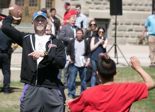 Blue Bombers QB Buck Pierce plays football with young students after it was announced he would be an adjunct coach with the University of Winnipeg and assist Dave Donaldson with his Inner City Youth Football Program.   130522 - Wednesday, May 22, 2013 - (Melissa Tait / Winnipeg Free Press)