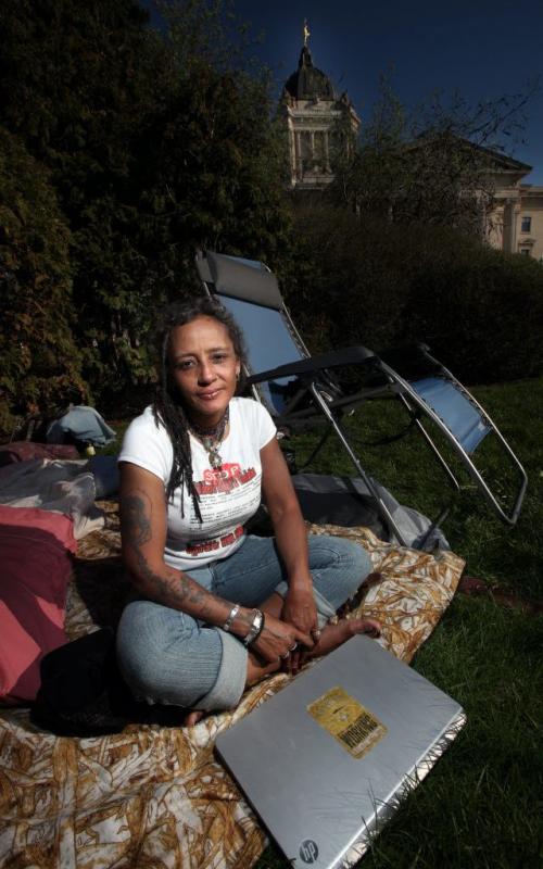 Social Activist Kim Edwards sits in her camp at the legislature Wednesday evening. She's set up camp  and is starting a hunger strike demanding to speak with Prime Minister Harper. She's pushing for a Royal Commission into Manitoba's Child Welfare System. Security told her she couldn't erect her tent so she's sleeping under a blanket stretched between two lawn chairs. See Mary Agnes Welch story. May 22, 2013 - (Phil Hossack / Winnipeg Free Press)