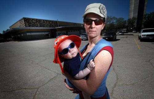 Marilynn Kullman and her 6 mo old son Ezra pose on the parking lot at the Fort Rouge Recreation and Leisure Center Wed. Mayor Katz tossed his gum littering the lot en-route to a local event last week.....See Gord Sinclair's story. May 22, 2013 - (Phil Hossack / Winnipeg Free Press)