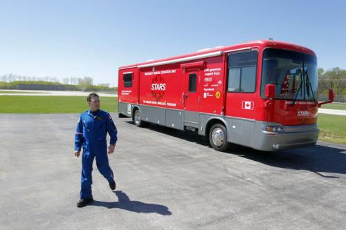 Flight paramedic Grant Therrien walks away from the mobile Emergency Medical Education unit. Photo taken at the STARS base on the airport grounds. The Shock Trauma Air Rescue Society (STARS) new mobile education program for rural health care providers at the STARS Winnipeg Base. May 23, 2013  BORIS MINKEVICH / WINNIPEG FREE PRESS