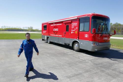 Flight paramedic Grant Therrien walks away from the mobile Emergency Medical Education unit. Photo taken at the STARS base on the airport grounds. The Shock Trauma Air Rescue Society (STARS) new mobile education program for rural health care providers at the STARS Winnipeg Base. May 23, 2013  BORIS MINKEVICH / WINNIPEG FREE PRESS