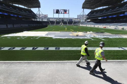 Workers begin to set up stage on the south end of the Investors Group Field for this Sunday's One Heart worship service a annual event in which over 60 local Christian churches gather together for a group church service.  The event is normally held at the MTS Centre but the football club offered to host the event to test out their new facility. Standup photo.May 23, 2013 Ruth Bonneville Winnipeg Free Press
