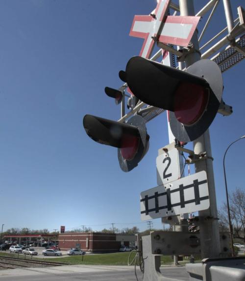 The train crossing across Marion St. near Rue Archibald. The train tracks pass by the Tim Hortons. with  story     (WAYNE GLOWACKI/WINNIPEG FREE PRESS) Winnipeg Free Press May 23 2013