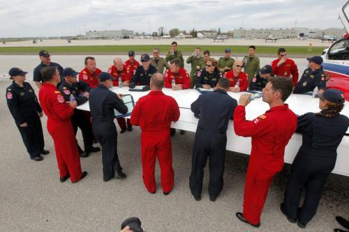 The Snowbirds flying team performs a show in Portage la Prairie Friday afternoon. In this photo they debrief after the show on one of the plane's wings.  May 24, 2013  BORIS MINKEVICH / WINNIPEG FREE PRESS