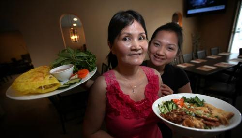 "Mama Ca" Huynh and her daughter Stacy show off bahn Xao (crepe) left and Delux Vermicelli at the family run restraunt Pho Binh Mink on Seargeant ave. See Marion's review.  May 24, 2013 - (Phil Hossack / Winnipeg Free Press)
