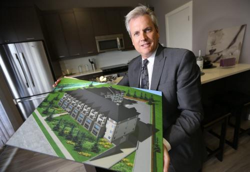 David Powell, of Powell Property Group, in the display kitchen at the Allure Condos Presentation Centre, with a rendering of a 73-unit condo development that will be built at 3411 Pembina Highway, Friday, May 24, 2013. (TREVOR HAGAN/WINNIPEG FREE PRESS)