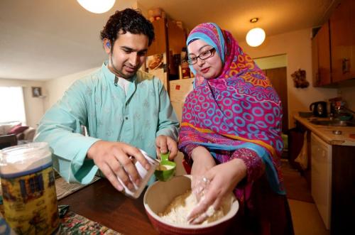 Mohammad Haider and Lubna Usmani making Gulab Jamun for Islamic Culture Day which takes place Sunday at the Grand Mosque, Friday, May 24, 2013. The dish is similar to a timbit, and is served soaked in a syrup. (TREVOR HAGAN/WINNIPEG FREE PRESS)