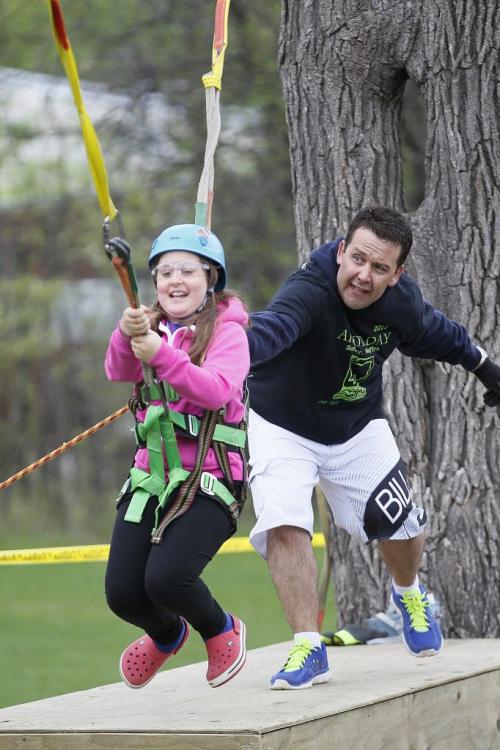 May 25, 2013 - 130525  - Simone Zahodnik (9) does the zipline with the help of volunteer Ray Perron (R) of Alliance Tree Care during the Arbor Day activities in Assiniboine Park in Winnipeg Saturday, May 25, 2013. John Woods / Winnipeg Free Press