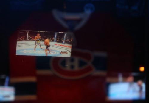 UFC 160 reflects off a framed Montreal Canadiens jersey at Boogies Diner on Main Street, Saturday, May 25, 2013. for randy turner upcoming story to run june 8th?? Despite the fact there is playoff hockey and basketball on, the UFC occupied nearly all the screens (TREVOR HAGAN/WINNIPEG FREE PRESS)