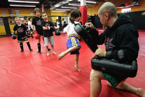 Hannah Sidhu, 5, works out with one of the trainers at the Canadian Fighting Centre on Wardlaw. 130523 May 23, 2013 Mike Deal / Winnipeg Free Press