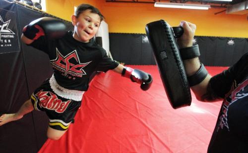 Connor Church, 10, works out with Giuseppe DeNatale, president of the Canadian Fighting Centre on Wardlaw. 130523 May 23, 2013 Mike Deal / Winnipeg Free Press