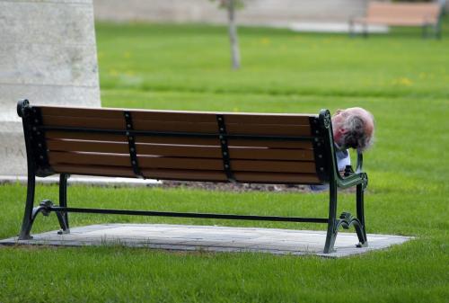 A man naps on a park bench at the Leg. May 27, 2013  BORIS MINKEVICH / WINNIPEG FREE PRESS