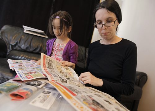 May 27, 2013 - 130527  - Nadine Chappellaz and her seven year old daughter Lea look through flyers for deals which she can post on her website called Save Money in Winnipeg Monday, May 27, 2013. John Woods / Winnipeg Free Press