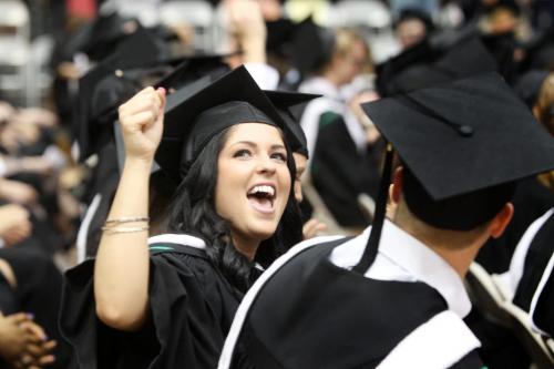 U of M Grad Raelyn McIntosh motions to her family her excitement during the 134th annual convocation ceremony at the Investors Group Athletic Centre Tuesday. Standup photo  May 28, 2013 Ruth Bonneville Winnipeg Free Press