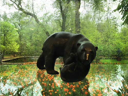 A sculpture of a mother bear and her cub displayed in the Leo Mol Garden Gallery located int he Leo Mol Garden appears to be in a midst of tulips in the garden due to the reflection in the glass display case. Standup Photo May 30, 2013 Ruth Bonneville Winnipeg Free Press