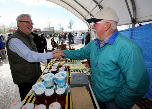 Premier Greg Selinger meets Charles Polcyn, owner of Scott's Hill Apiary, a honey producer, at the St. Norbert Farmers Market on its opening day of the season, Saturday, June 1, 2013. (TREVOR HAGAN/WINNIPEG FREE PRESS)