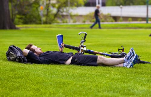 Matt Lewis enjoys nothing more than reading in the grass at the leg. BORIS MINKEVICH / WINNIPEG FREE PRESS June 6, 2013