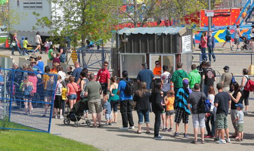 Brandon Sun Fair goers line up at the south end of the Keystone Centre to enter into the Manitoba Summer Fair. All visitors will have to park in the south end of the grounds and enter through one admissions gate. (Bruce Bumstead/Brandon Sun)
