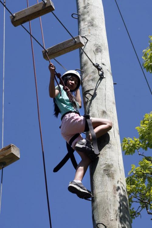 in pic climbing to Giant Steps rope ladder- Tyndall Park Community School  student Juliana  VALDORIA  is attending Y Camp Douglas  summer camp  in Warren , she is taking part in a Giant Steps climbing activity that hass her waking on a rope ladder 40ft above the ground. Other events include bike riding and swimming . reporter nick martin story , school project-  KEN GIGLIOTTI / JUNE 6 2013 / WINNIPEG FREE PRESS