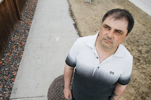 Island Lakes resident Richard Hywaky outside his home on Friday, June 7, 2013. He refuses to mow the city boulevard bordering his property and says it's an infringement of his rights to force him to do so. (ALDO SANTIN) (JESSICA BURTNICK/WINNIPEG FREE PRESS)