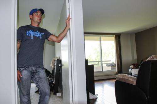 Twenty six year old Chad Ell is a first-time home buyer - he bought a one-bedroom condo on Beliveau Rd. and is now moved in. He's pictured here in his new condo on Friday, June 7, 2013. (MCNEILL) (JESSICA BURTNICK/WINNIPEG FREE PRESS)
