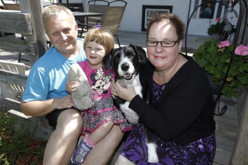 June 8, 2013 - 130608  - Angie and Ray Stephenson with dog Molly and 2 year old daughter Amelia with a teddy bear first responders gave her after their car was broadsided by a driver who ran a red light. Photographed at their home Saturday, June 8, 2013. John Woods / Winnipeg Free Press