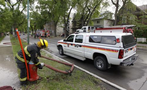 Residents of a 4 storey apartment building looked on as fire fighters knocked down a fire on the 400 block of Maryland Street, just south of Ellice Avenue, Saturday June 9, 2013. (TREVOR HAGAN/WINNIPEG FREE PRESS)