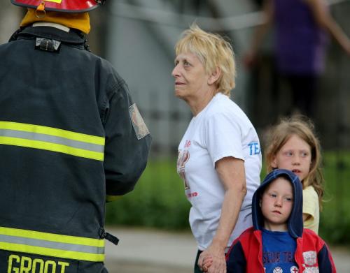 A resident speaks with a firefighter at the scene of a fire in an apartment building on the 400 block of Maryland Street, Saturday, June 8, 2013. (TREVOR HAGAN/WINNIPEG FREE PRESS)