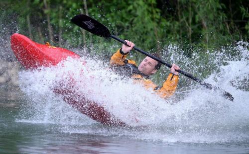Mick Lautt does a trick at the bottom of the tobaggan slide on his white water kayak at MEC Paddlefest at FortWhyte Alive, Sunday, June 9, 2013. (TREVOR HAGAN/WINNIPEG FREE PRESS)