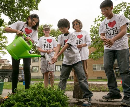 Students from Champlain School planted a butterfly garden outside the North Winds property management offices at Main St and Anderson Ave on Monday. Grade 6 students, from left, Maddy Day, Hope Shappee, Carlos De Leon, Ian Delacruz and Education Assistant Gene Walstrom. 130610 - Monday, June 10, 2013 - (Melissa Tait / Winnipeg Free Press)