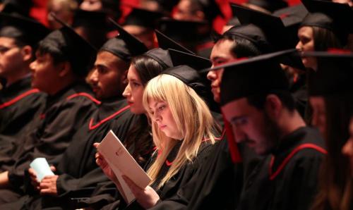 Can't tell the players without a program, an RRC graduate reads patiently in her seat waiting to receive her diploma Monday night at the Concert Hall. Nick Martin tale. June 10, 2013 - (Phil Hossack / Winnipeg Free Press)