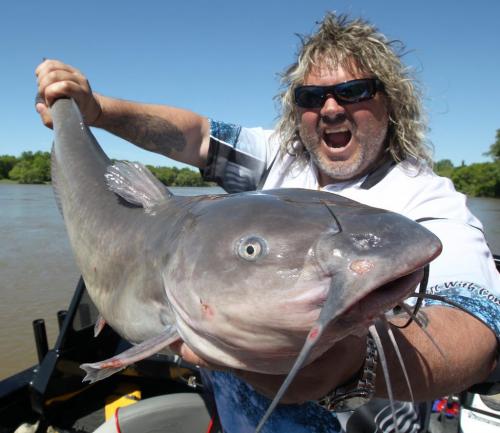 Known as the Rock n Roll fisherman guide Todd Longley of City Cats holds one of three master angler channel cat fish caught in his boat on the Red River during the second annual province of Manitoba Fish Tales media day today- The goal is to showcase Manitobas world class fishing to local media-  focusing on accessibility, diversity and conservation  All giant catfish, including this one caught by Breakfast Televisions Drew Kozub were safely released back into the Red River- Standup Photo- June 11, 2013   (JOE BRYKSA / WINNIPEG FREE PRESS)