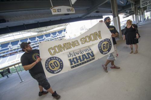 Wednesday June 11, 2013 - Winnipeg - DAVID LIPNOWSKI / WINNIPEG FREE PRESS  Shawarma Khan Owner Ibrahim "Obby" Khan and his Head Chef Manager Mohammed Ali Ben-Ahmad look at where they will hang their sign at Investors Group Field. Shawarma Khan In The Snap will not be open for the first Winnipeg Blue Bomber exhibition home game on June 12, 2013, but should be open for the first regular season home game.
