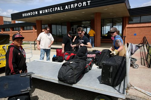 Brandon Sun 12062013 Bags are unloaded from a plane in front of the Brandon Municipal Airport for evacuees from Ilford and York Factory First Nation on Wednesday. (Tim Smith/Brandon Sun)