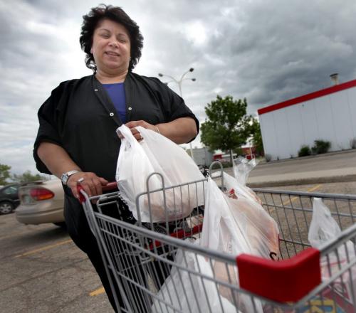 Kathy Nicolaou leaves Safeway with her grocery cart Wednesday, see Mary Agnes story. June 12, 2013 - (Phil Hossack / Winnipeg Free Press)