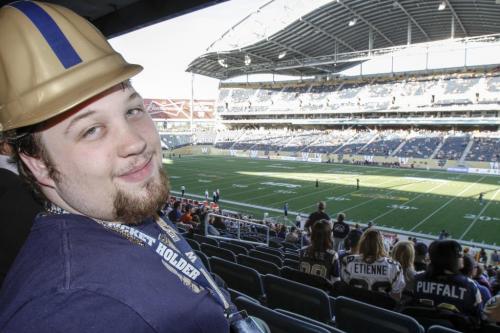 Bomber Fan Nathan Seager talks to Free Press reporter Carol Sanders about the view from the lower deck in Section 126 at the new Investors Field Stadium. The inaugural Winnipeg Blue Bombers game at the new Investors Field Stadium was played against the Toronto Argonauts on Wednesday, June 12, 2013. (CAROL SANDERS) (JESSICA BURTNICK/WINNIPEG FREE PRESS)
