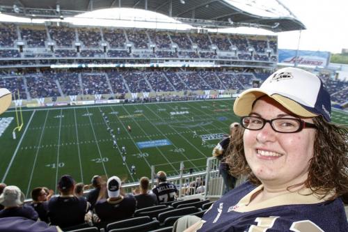 Bomber Fan Felise Coutu talks to Free Press reporter Carol Sanders about the view from the upper deck at the new Investors Field Stadium. The inaugural Winnipeg Blue Bombers game at the new Investors Field Stadium was played against the Toronto Argonauts on Wednesday, June 12, 2013. (CAROL SANDERS) (JESSICA BURTNICK/WINNIPEG FREE PRESS)