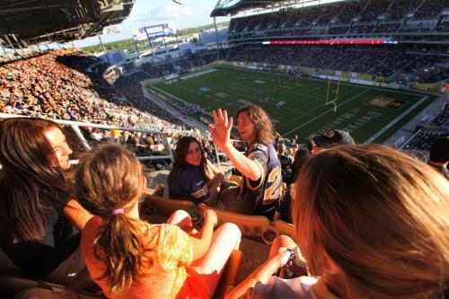 Winnipeg Blue Bomber fans cheer on the Bombers  at Investors Group Field Wednesday evening.  Names  - Dave Dupont (long curly hair), his brother Alex Dupont, and his girlfriend Brooke Foster.   June 12. 2013 Ruth  Bonneville, Winnipeg Free Press stadium