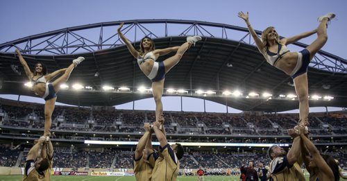 The Blue Lightning cheerleading squad continued to perform for fans as dusk fell over the new Investors Group Field Stadium. The inaugural Winnipeg Blue Bombers game at the new Investors Field Stadium was played against the Toronto Argonauts on Wednesday, June 12, 2013. (JESSICA BURTNICK/WINNIPEG FREE PRESS)