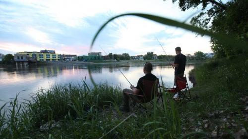 David Sylvestre  and his cousin Justin Rioux enjoy an evening fishing on the Red River near Whittier Park Thursday. Standup photo. Photography by Ruth Bonneville Winnipeg Free Press June 13,, 2013