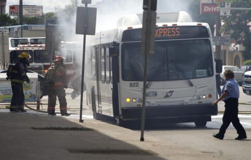 Firefighters extinguish a blaze in a transit bus that experienced mechanical difficulty on the 1200 block of Portage Avenue, Saturday, June 15, 2013. (TREVOR HAGAN/WINNIPEG FREE PRESS)