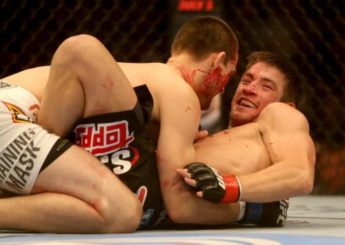 Sam Stout laughs at the crowds reaction as they show he received a very deep cut over his eye by James Krause during their lightweight bout at UFC 161 in Winnipeg, Manitoba, Saturday, June 15, 2013. (TREVOR HAGAN/WINNIPEG FREE PRESS)