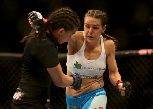 Alex Davis, right, fires a right hand at Rosi Sexton during their bantamweight bout at UFC 161 in Winnipeg, Manitoba, Saturday, June 15, 2013. (TREVOR HAGAN/WINNIPEG FREE PRESS)