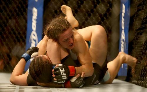 Alex Davis lays on Rosi Sexton during their bantamweight bout at UFC 161 in Winnipeg, Manitoba, Saturday, June 15, 2013. (TREVOR HAGAN/WINNIPEG FREE PRESS)