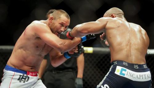 Dan Henderson (left) takes a shot from Rashad Evans during their Light Heavyweight main card fight at UFC 161. Evans won on a split decision. 130616 - Sunday, June 16, 2013 - (Melissa Tait / Winnipeg Free Press)