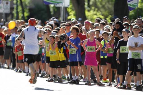 Runners are greeted by a colourful crowd in front of Laura Secord School in Wolseley during the Manitoba Marathon in Winnipeg on Sunday, June 16, 2013. The school was also a relay exchange zone. (JESSICA BURTNICK/WINNIPEG FREE PRESS)