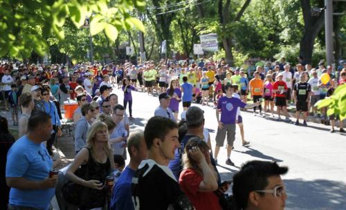 Runners are greeted by a colourful crowd in front of Laura Secord School in Wolseley during the Manitoba Marathon in Winnipeg on Sunday, June 16, 2013. The school was also a relay exchange zone. (JESSICA BURTNICK/WINNIPEG FREE PRESS)