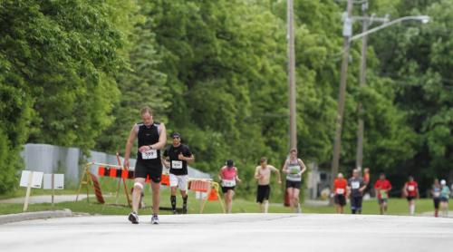 An injured runner (at left) pushes through the pain at Mile 24 of the Manitoba Marathon on River Rd. in Winnipeg on Sunday, June 16, 2013. (JESSICA BURTNICK/WINNIPEG FREE PRESS)