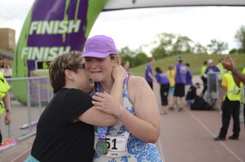 Jayne Mullen cries and hugs her mother after finishing her marathon at the last minute in Winnipeg on Sunday, June 16, 2013. (OLIVER SACHGAU / WINNIPEG FREE PRESS) Manitoba Marathon